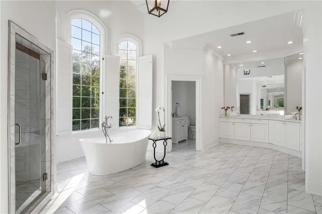 an aerial view of residential house with outdoor space and trees all around