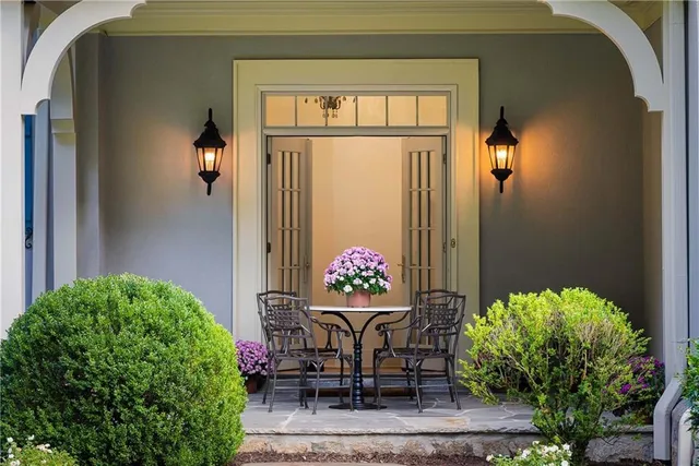 a vase of flowers sitting on a table near a window