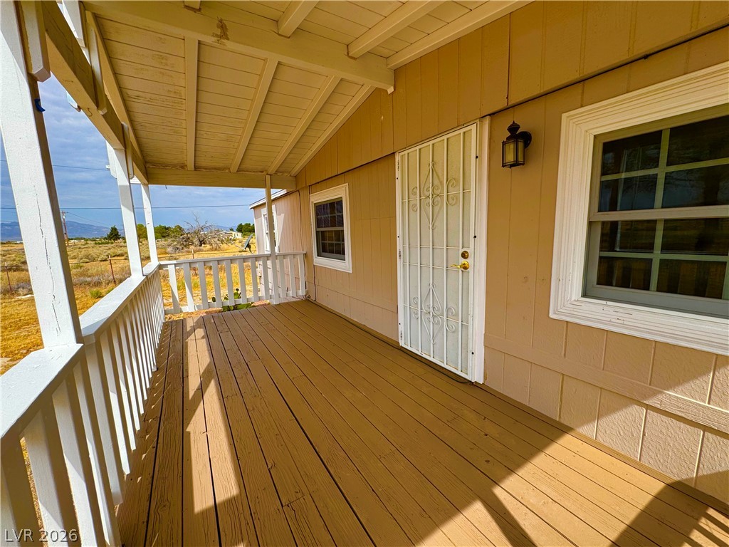 An inviting covered porch offers panoramic views of the distant mountains and arid landscape.