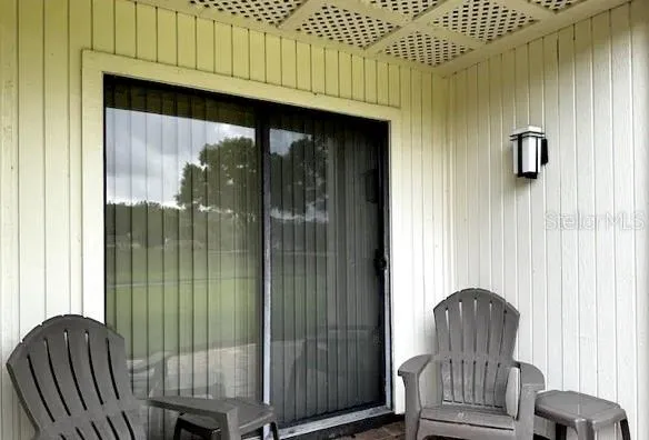 a view of a porch with furniture and wooden floor