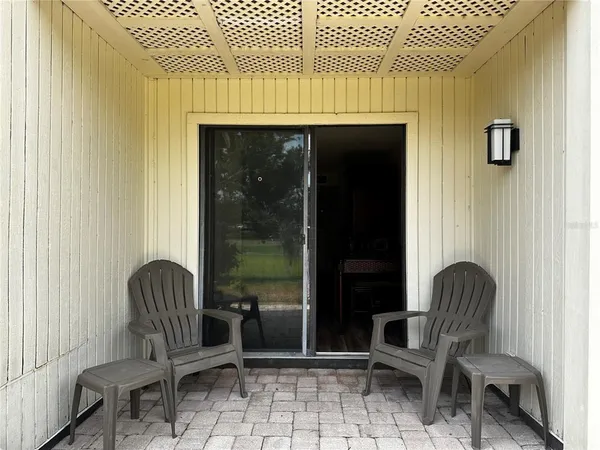 a chair and table sitting in front of a door