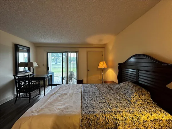 a bedroom with a bed and wooden table