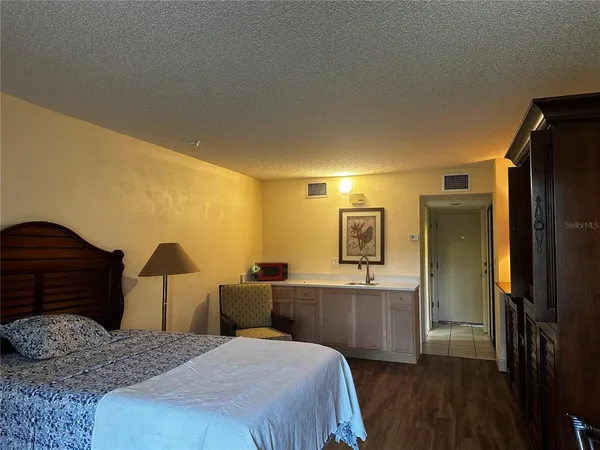 a bedroom with a bed and a dresser