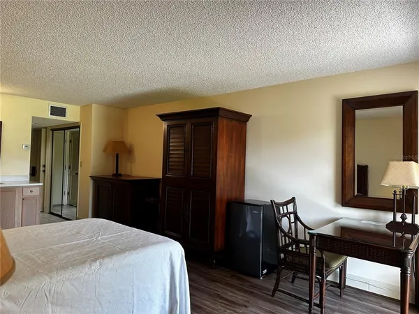 a bedroom with a bed and a table in it