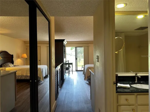 a view of a hallway with wooden floor
