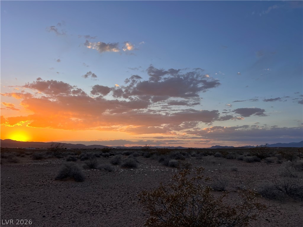 North Ishimoto Overton, NV 89040 - Photo 1 of 10 Witness an enchanting desert sunset with golden hues illuminating the vast, undeveloped landscape.