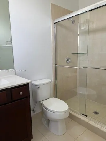 a bathroom with a shower a toilet and a sink