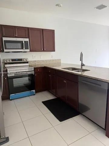 a kitchen with a sink and a stove