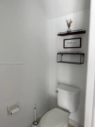 a white toilet sitting next to a bathroom sink