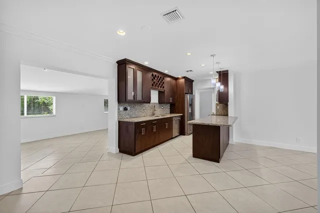 a kitchen with granite countertop a sink and a stove