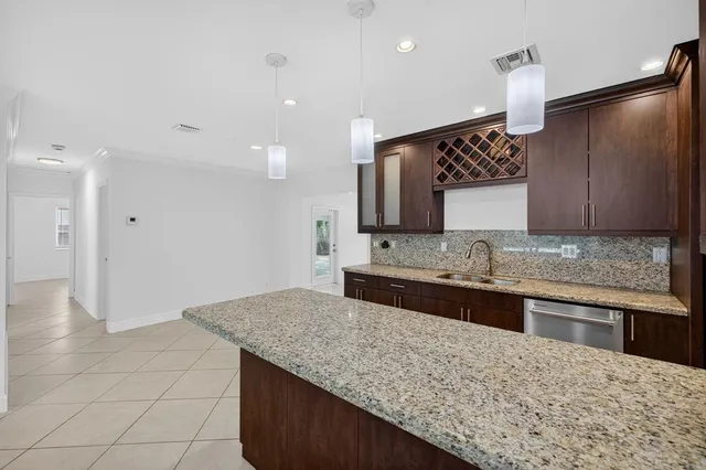 a kitchen with stainless steel appliances granite countertop a sink and a stove