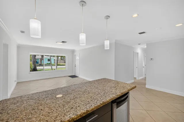 a bathroom with a granite countertop sink a mirror and shower