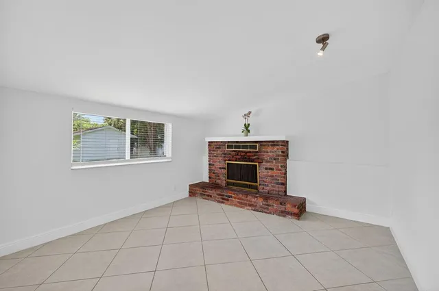 a view of empty room with stairs and windows