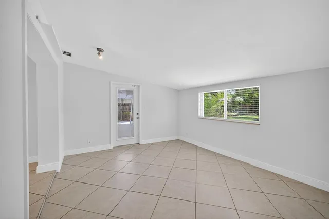 a view of an house with backyard and a area