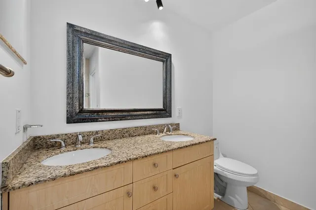 a view of a backyard with potted plants and large trees