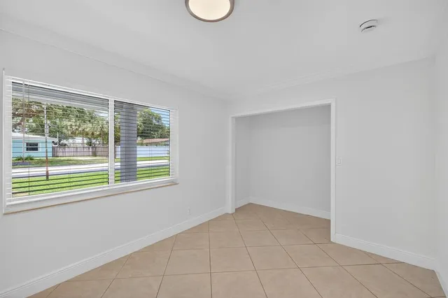 an aerial view of residential houses with outdoor space and trees
