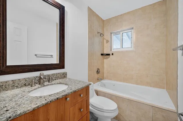 an aerial view of residential houses with outdoor space and trees