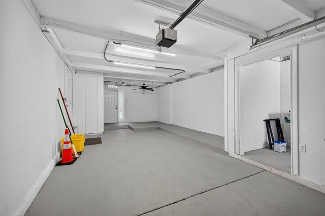 an aerial view of residential houses with outdoor space and trees