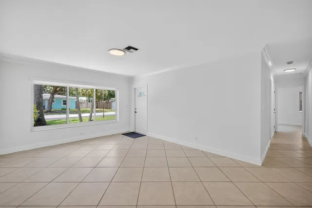 a large kitchen with a stove a sink a microwave and a refrigerator