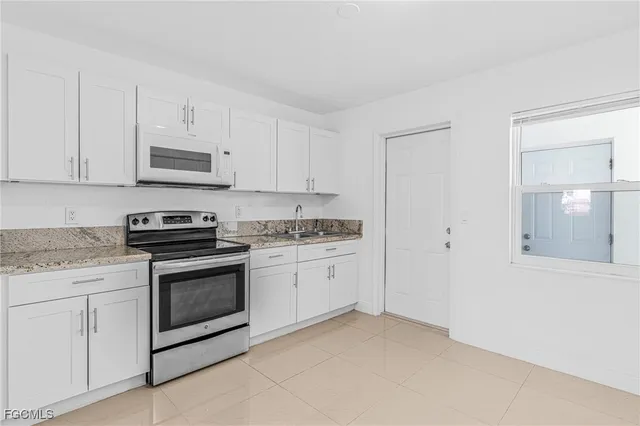 a view of a hallway with wooden cabinet