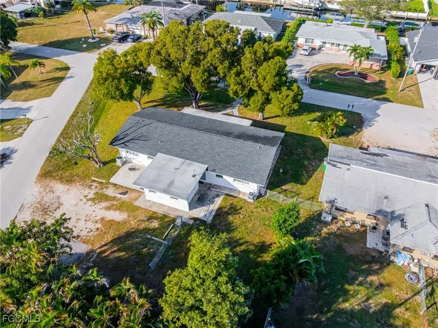 an aerial view of multiple houses with yard