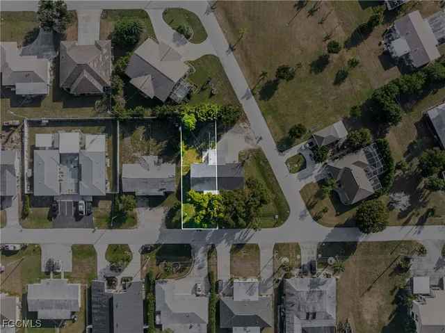 an aerial view of a house with a yard