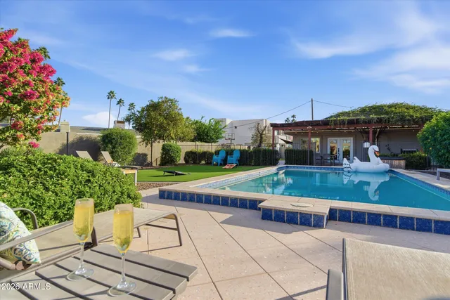 a view of yard with swimming pool and green space