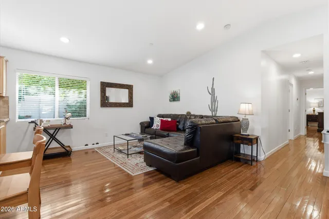 a living room with furniture and a wooden floor