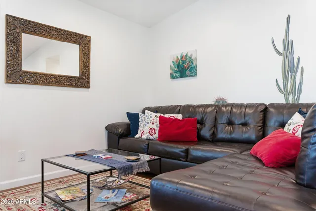 a living room with furniture and wooden floor