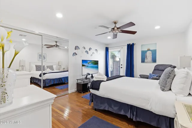 a bedroom with a large bed and a chandelier