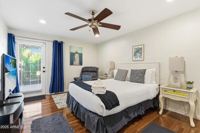 a bedroom with a bed a couch and a window