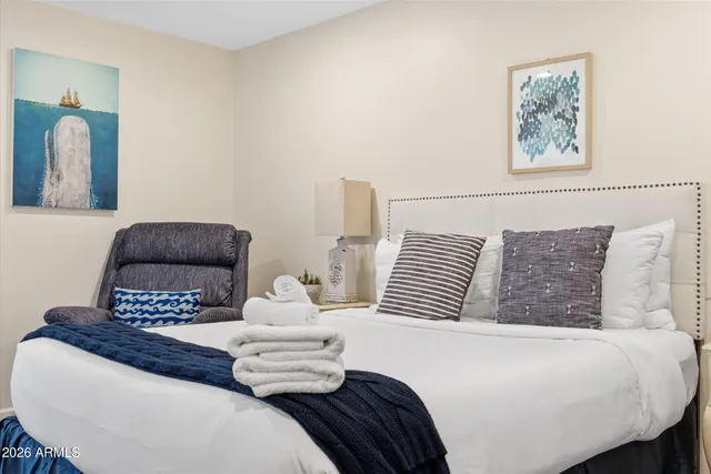 a bedroom with a bed and a chair