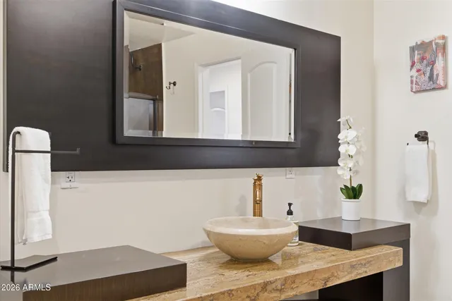 a bathroom with a sink and a mirror