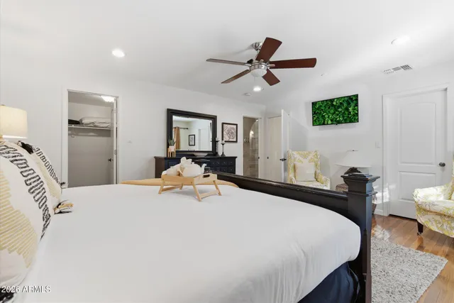 a bedroom with a bed and wooden floor