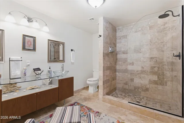 a bathroom with a sink a toilet and shower