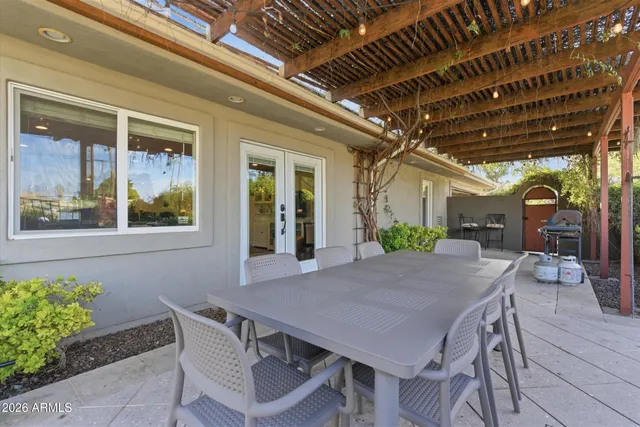 a view of a patio with table and chairs with potted plants