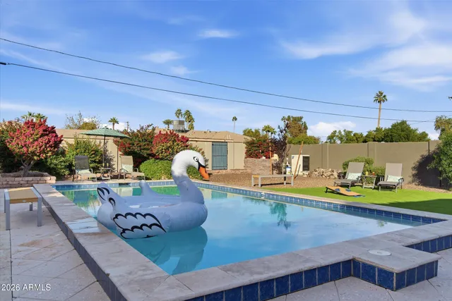 a view of a swimming pool with an outdoor seating