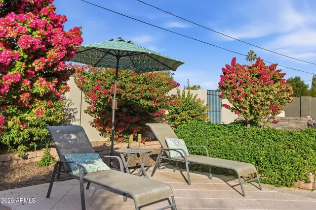 a view of a chairs and table in the patio