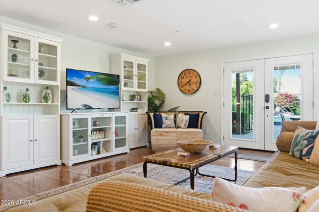 a living room with furniture a rug and a window