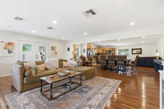 a living room with lots of furniture and view of kitchen