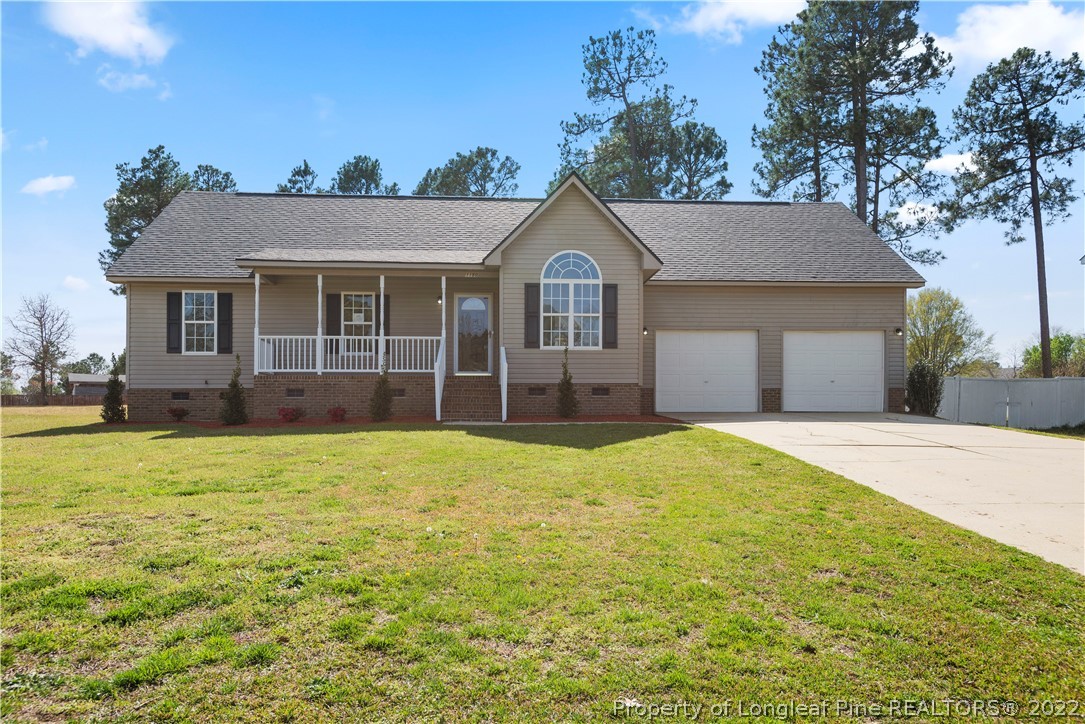 1150 Roundabout Road Cameron, NC 28326 - Photo 1 of 22 a front view of a house with a garden
