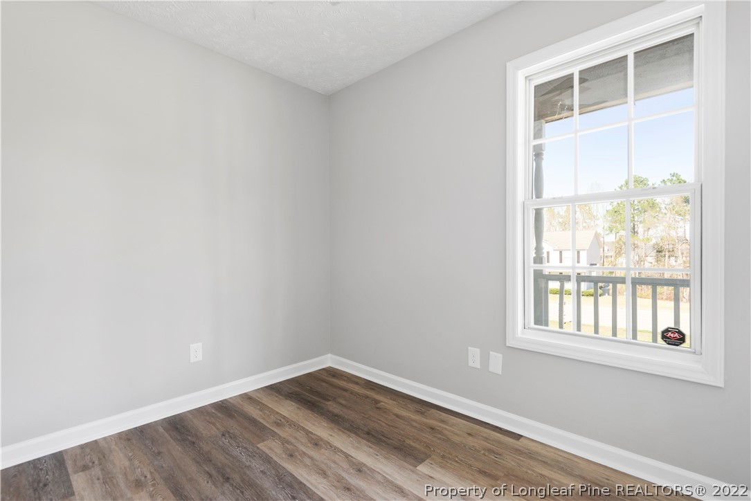 1150 Roundabout Road Cameron, NC 28326 - Photo 16 of 22 a view of an empty room with wooden floor and a window