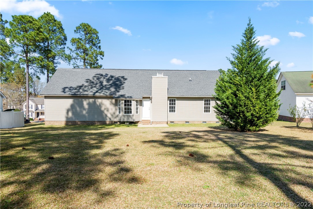 1150 Roundabout Road Cameron, NC 28326 - Photo 21 of 22 a view of a house with a yard and garage