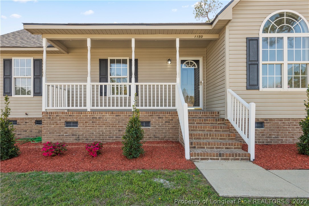 1150 Roundabout Road Cameron, NC 28326 - Photo 4 of 22 front view of a house with a yard
