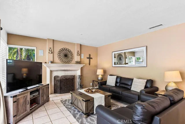 a living room with furniture a flat screen tv and a fireplace
