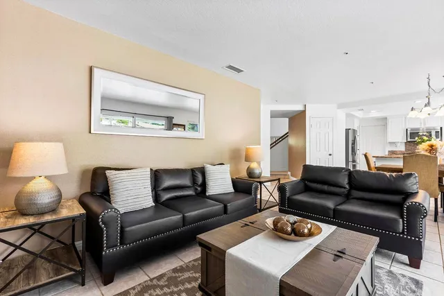 a living room with furniture and a lamp