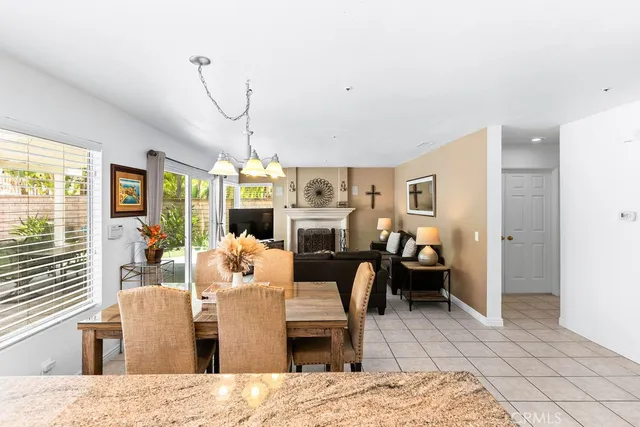 a living room with furniture a fireplace and a table
