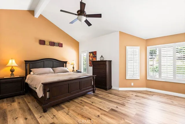 a spacious bedroom with a bed and a window
