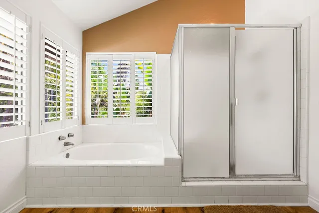 a bathroom with bathtub and a shower