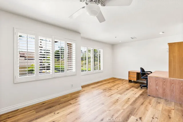 a bedroom with a bed and a table with window